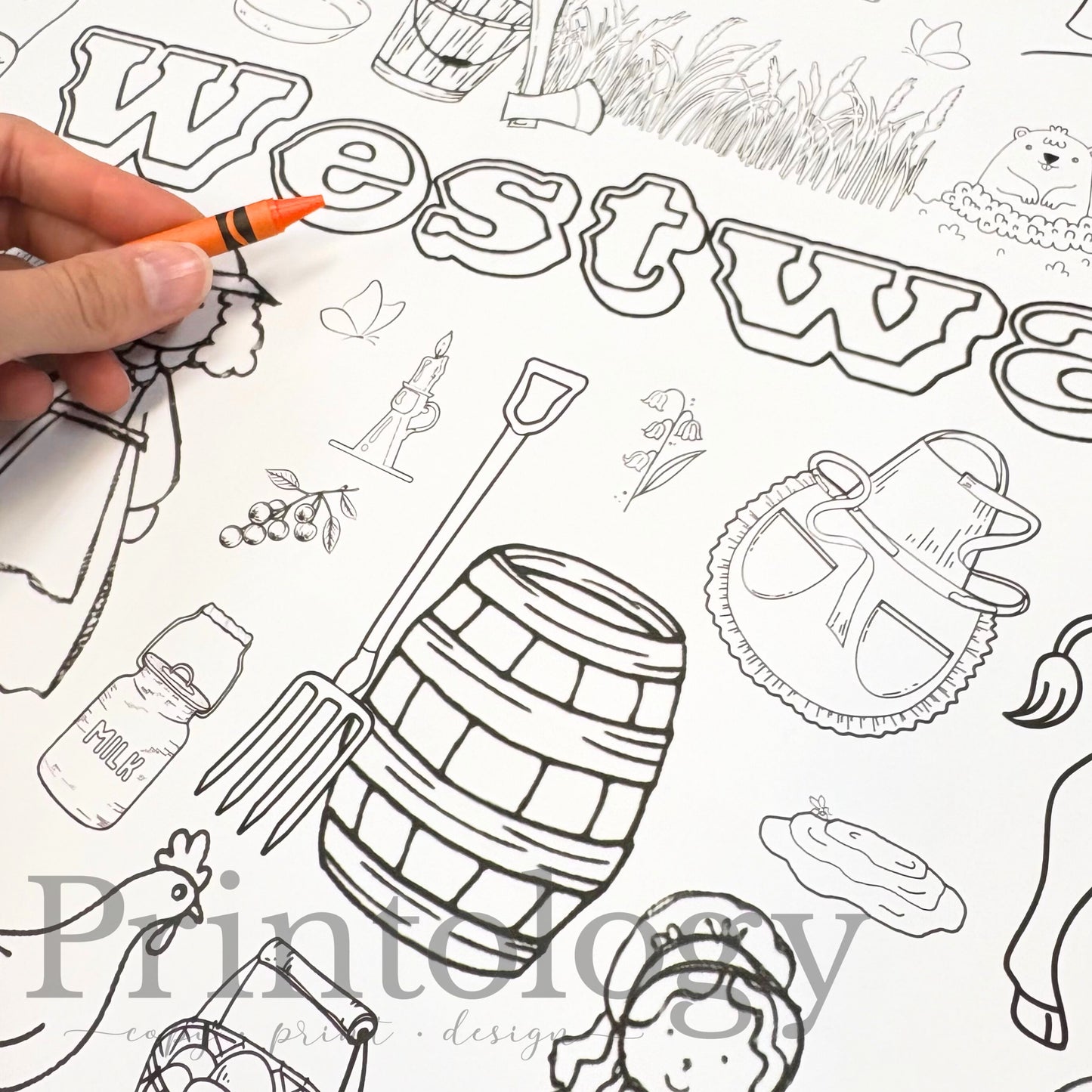 Giant Coloring page with 'Westward' text and various illustrations including a barrel, apron, prairie grass, etc, being colored with a crayon.