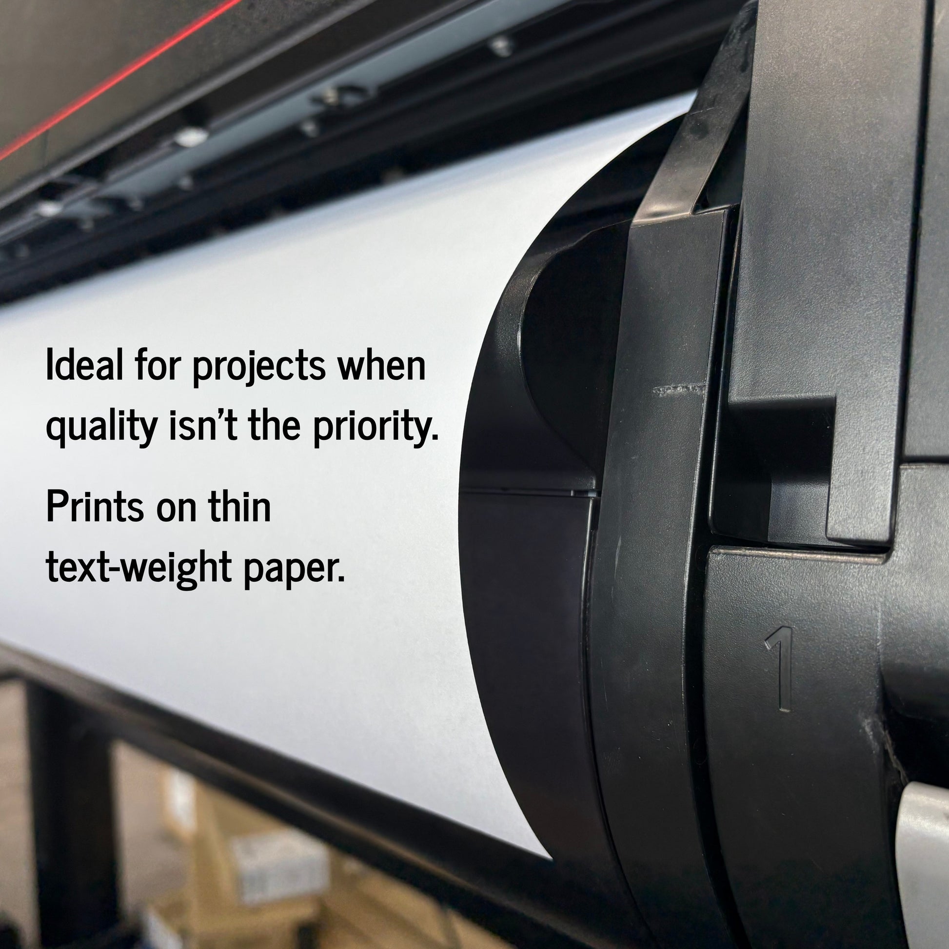 Close-up of a large black printer with a white roll of paper inside, overlaid with the text: 'Ideal for projects when quality isn't the priority. Prints on thin text-weight paper.