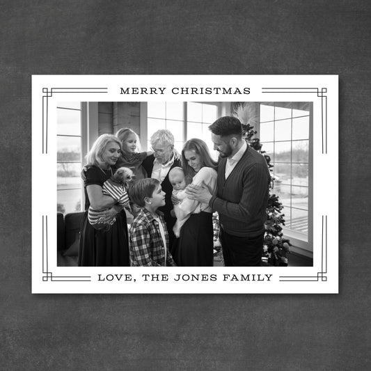 Black and white family photo with 'Merry Christmas' text on a decorative card.