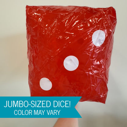 A large glossy inflatable dice with white circular dots, held up by a hand against a plain light background. A blue banner at the bottom reads 'JUMBO-SIZED DICE! COLOR MAY VARY'.