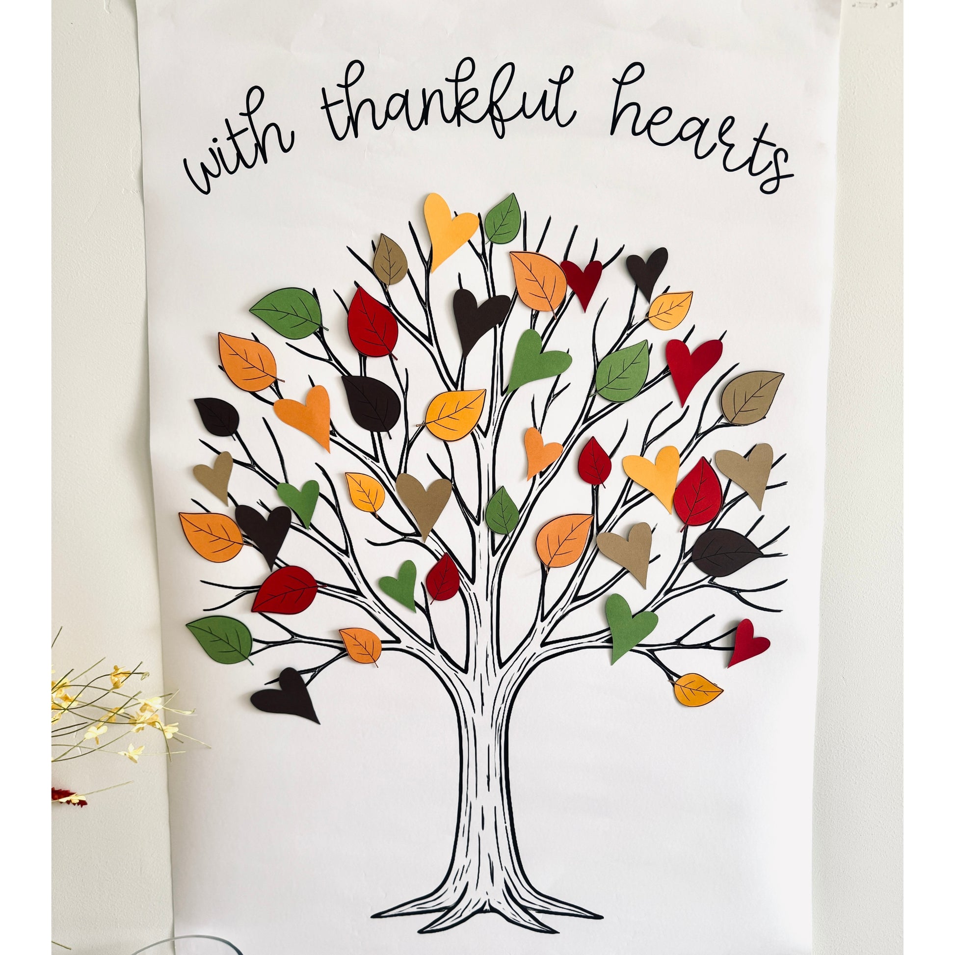 Decorative wall art poster with a tree design and colorful paper leaves on a white background.